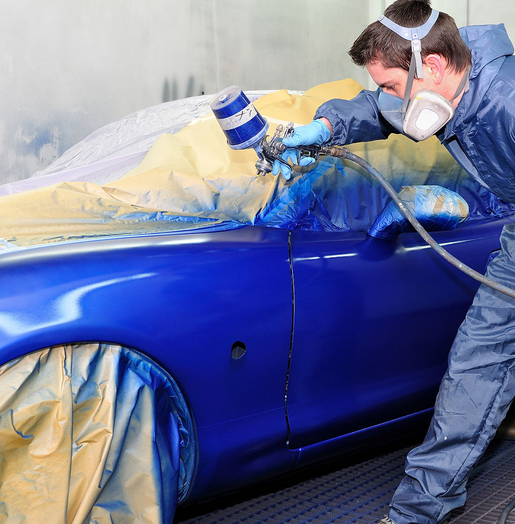 Professional painter working on car repair